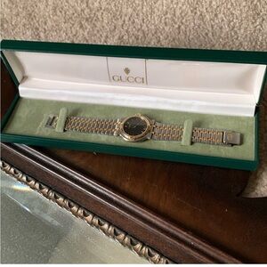 Gucci Women’s Black and Gold Bracelet Watch